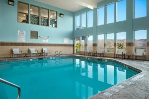 uma piscina com cadeiras e mesas num edifício em Holiday Inn Express Lewiston, an IHG Hotel em Lewiston