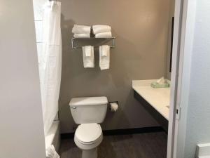a bathroom with a toilet and a sink and towels at Studio 6 Killeen TX in Killeen