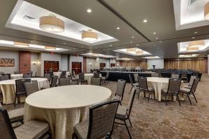 a banquet hall with white tables and chairs at Drury Plaza Hotel New Orleans in New Orleans