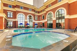a large swimming pool in a building with a building at Drury Plaza Hotel New Orleans in New Orleans