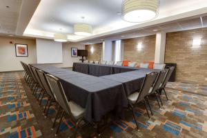 a conference room with a long table and chairs at Pear Tree Inn Sikeston in Sikeston