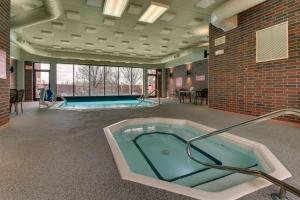 a hot tub in a room with a pool table at Drury Inn & Suites Poplar Bluff in Poplar Bluff