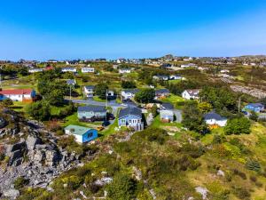 an aerial view of a village with houses on a hill at Belle Vue Cottage - Upper Island Cove in Upper Island Cove