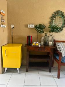 a wooden table with a yellow box next to a wall at Executive207. Suíte completa com frigobar in Fortaleza