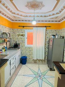 a kitchen with a star pattern on the floor at appartement Ocean in Tamraght Ouzdar