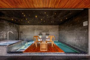 a swimming pool with a table and chairs in a house at Live Aqua Monterrey in Monterrey