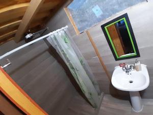 a bathroom with a sink and a mirror at Glamping Cabaña el Porvenir 10601 in Manta