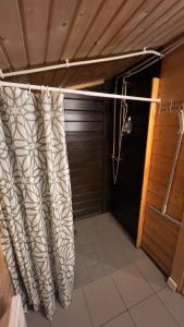 a shower curtain in a room with a garage at Artur´s Eaterie and Holiday home in Viitna
