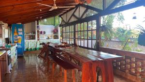 a dining room with a wooden table and chairs at Mario Algarin in Puerto Iguazú
