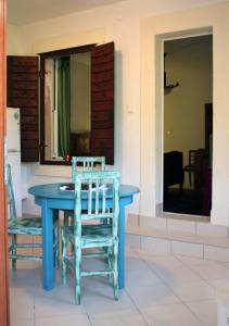 a blue table and chairs in a room at Hill House Marija in Komiža
