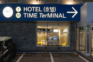 un terminal del hotel con un reloj en un estacionamiento en Hotel TimeTerminal by Annk en Daejeon