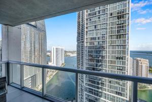 a view from the balcony of a skyscraper at *W ICON BRICKELL- LUXURY 2BR HIGHRISE CORNER CONDO** in Miami
