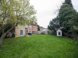 a yard of a house with a grass yard at Large 4 Bed House near River Thames in Old Windsor