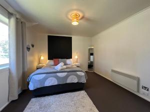 a bedroom with a bed and a large window at Boomers Retreat, Alonnah, Bruny Island in Alonnah