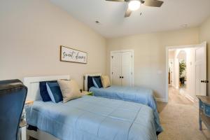 two beds in a bedroom with blue sheets at Charming Alabama Retreat with Patio and Pool Access! in Owens Cross Roads