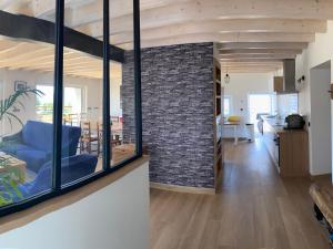 a living room and dining room with a brick wall at Gîte spacieux 10 pers à Vagney - Sauna, jeux, proche Gérardmer - FR-1-589-400 in Vagney +27 photos