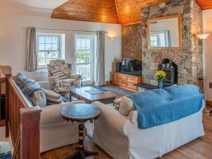 a living room with a couch and a fireplace at The Old Canoe Club in Millbrook