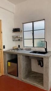 a stone counter with a window in a room at Casa Roma in Taxco de Alarcón