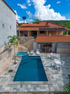 a swimming pool in front of a house at Casa Santos - Pirenópolis in Pirenópolis