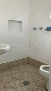 a bathroom with a sink and a toilet at Casa Roma in Taxco de Alarcón