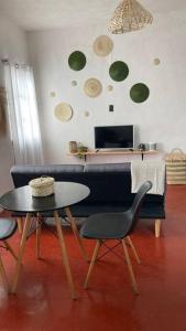 a living room with a couch and a table and chairs at Casa Roma in Taxco de Alarcón