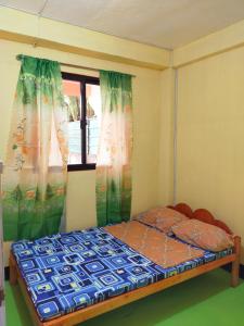 a bedroom with a bed in front of a window at Aunora Rooms 