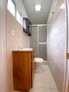 a bathroom with a toilet and a sink and a shower at MARIA III HOSTAL in Juayúa