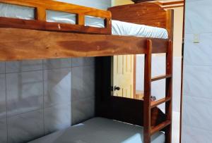 two bunk beds in a room with a door at RedDoorz @ PVC Pension Haus in Tagum