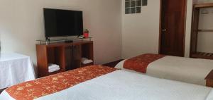 TV a/nebo společenská místnost v ubytování Hotel Romero Machupicchu + 8 fotografií