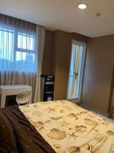 a bedroom with a large bed and a window at Cozyroom bintaro @ bintaro icon in South Tangerang