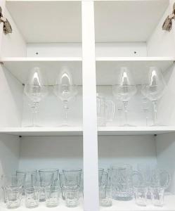 a bunch of wine glasses sitting on a shelf at Stay Mono in Incheon