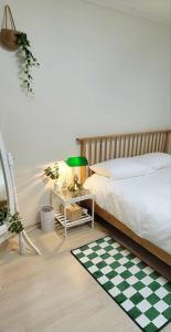 a bedroom with a bed and a checkerboard floor at Stay Mono in Incheon