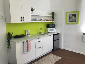 a kitchen with a sink and a microwave at Tropical Apartments in Miramar in San Juan