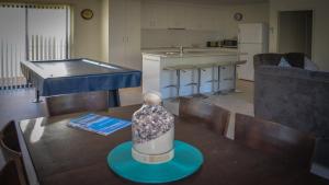 a kitchen and a table with a vase on it at Lords Retreat in Coffin Bay