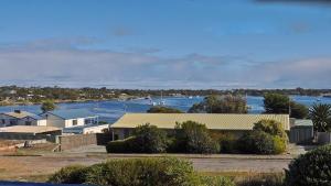 a view of a river with houses and a harbor at Mariners View Coffin Bay in Coffin Bay