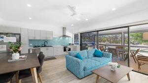 a kitchen and living room with a couch and a table at The Boathouse in Coffin Bay