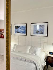 a bedroom with a bed with three pictures on the wall at Flat no Itaim in São Paulo