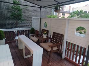 a patio with a table and chairs and an umbrella at All In One Guesthouse in Incheon