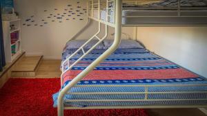 a bunk bed with a ladder in a room at Seascape in Coffin Bay