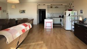 a kitchen and living room with a couch and a refrigerator at Seascape in Coffin Bay