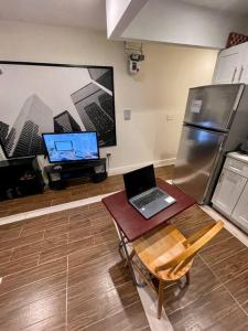 a kitchen with a laptop computer sitting on a table at Elegant 2 Bedrooms 14 minutes to Times Square! in Weehawken