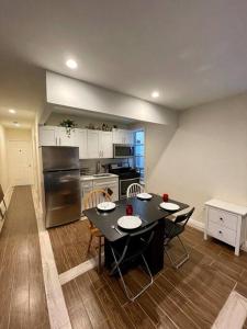 a kitchen with a table and chairs in a kitchen at Elegant 2 Bedrooms 14 minutes to Times Square! in Weehawken