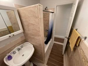 a bathroom with a toilet and a sink and a shower at Elegant 2 Bedrooms 14 minutes to Times Square! in Weehawken