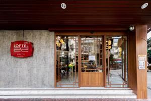 a store front with a sign on the side of a building at Loftel 22 Hostel in Bangkok