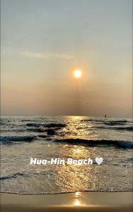 a sunset on the beach with the words hug him peach at VarietyD-DayHostel HuaHin in Hua Hin
