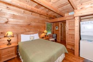 a bedroom with a bed in a log cabin at Creekside cabin in Townsend