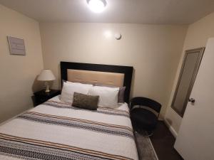 a bedroom with a bed with a black headboard and pillows at The Spot in Stonehurst