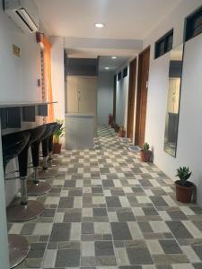 a hallway with a checkered floor in a building at MSG LODGING HOME in Puerto Princesa City