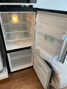 an open refrigerator with its door open and its contents at Tokyo Stay Dolce in Tokyo