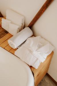 - une étagère avec des serviettes et du papier toilette sur un lit dans l'établissement La Poza Boutique Hotel and Spa - Adults 15 plus, à Todos Santos